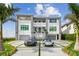 Elegant two-story home with a well-manicured lawn with luxury cars, showcasing modern architectural design at 90 Martinique Ave, Tampa, FL 33606