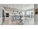Gourmet kitchen and dining room boasting modern appliances, sleek countertops and a glass dining table at 90 Martinique Ave, Tampa, FL 33606