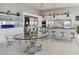 Modern kitchen and dining room featuring state-of-the-art appliances and a glass dining table at 90 Martinique Ave, Tampa, FL 33606