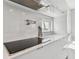 Modern kitchen featuring a Wolf cooktop, sleek white countertops and cabinetry and pot filler at 90 Martinique Ave, Tampa, FL 33606