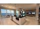 Bright kitchen island with a black countertop overlooking dining and living areas with beautiful water views at 90 Martinique Ave, Tampa, FL 33606