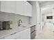 Convenient kitchenette with modern cabinetry, stainless steel appliances, and sleek countertop at 90 Martinique Ave, Tampa, FL 33606