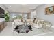 Well-lit living room with a zebra-striped rug, comfortable seating, and modern decor at 90 Martinique Ave, Tampa, FL 33606