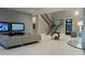 Contemporary living room boasts a modern staircase, sleek furniture, and unique lighting fixtures at 90 Martinique Ave, Tampa, FL 33606