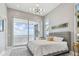 Serene bedroom with access to balcony offering water views, and stylish modern lighting at 90 Martinique Ave, Tampa, FL 33606