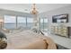 Elegant main bedroom with water views, chandelier, and access to a private balcony at 90 Martinique Ave, Tampa, FL 33606