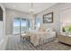 Charming bedroom with cozy bedding, stylish rug, and balcony access overlooking scenic water views at 90 Martinique Ave, Tampa, FL 33606