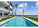 A luxurious pool with ocean views, a modern addition to a waterfront property with meticulously maintained landscaping at 90 Martinique Ave, Tampa, FL 33606