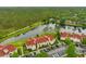 Beautiful aerial view of community, serene lake, lush trees, and ample parking, perfect for new residents at 9481 Highland Oak Dr # 1206, Tampa, FL 33647