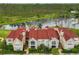 Aerial view of community showcases manicured lawns, beautiful lake, and red tile roofs perfect for tranquil living at 9481 Highland Oak Dr # 1206, Tampa, FL 33647