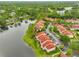 Stunning aerial view of the community highlights water views, lush greenery, and ample parking at 9481 Highland Oak Dr # 1206, Tampa, FL 33647