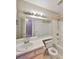 Bright bathroom features white tile, updated lighting, and a shower-tub combination, perfect for everyday use at 9481 Highland Oak Dr # 1206, Tampa, FL 33647
