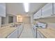Bright kitchen featuring white appliances and a breakfast bar, seamlessly connects to living areas at 9481 Highland Oak Dr # 1206, Tampa, FL 33647