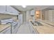 Well-lit kitchen with white appliances, cabinets, and neutral countertops at 9481 Highland Oak Dr # 1206, Tampa, FL 33647