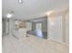 Open kitchen and living space with white cabinets and breakfast bar at 9481 Highland Oak Dr # 1206, Tampa, FL 33647