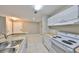 Updated kitchen featuring white appliances and countertops, seamlessly blending into the living area at 9481 Highland Oak Dr # 1206, Tampa, FL 33647