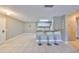 Open-concept living room with tile flooring, breakfast bar, and view into the kitchen at 9481 Highland Oak Dr # 1206, Tampa, FL 33647