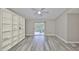 Bright living room with wood-look floors and built-in shelving at 9481 Highland Oak Dr # 1206, Tampa, FL 33647
