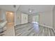 Bright living room with modern flooring, ceiling fan, and sliding glass doors to the balcony at 9481 Highland Oak Dr # 1206, Tampa, FL 33647