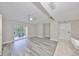 Bright living room with wood-look floors and access to a private balcony at 9481 Highland Oak Dr # 1206, Tampa, FL 33647