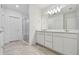 Bathroom with double vanity and glass enclosed shower with subway tile at 10418 Cross River Trl, Parrish, FL 34219