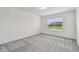 Carpeted bedroom with large window and natural light at 10418 Cross River Trl, Parrish, FL 34219