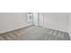 Minimalist bedroom with soft carpeting, a window with blinds, and a door leading to other areas of the home at 10418 Cross River Trl, Parrish, FL 34219