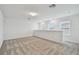 Spacious bonus room features neutral-toned walls, plush carpeting, and ample natural light from several windows at 10418 Cross River Trl, Parrish, FL 34219