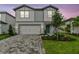 Charming two-story home with a well-manicured lawn, a two-car garage, and a welcoming front entrance at 10418 Cross River Trl, Parrish, FL 34219