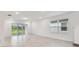 Spacious living room featuring tile flooring, large windows, and sliding glass door at 10418 Cross River Trl, Parrish, FL 34219