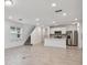 Open-concept room with tile flooring leading to the kitchen and stairs at 10418 Cross River Trl, Parrish, FL 34219