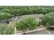 Overhead view of townhomes with parking, mature trees, and common green spaces at 10906 Keys Gate Dr, Riverview, FL 33579