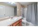 Cozy bathroom with a shower-tub combo and a vanity with ample counter space and storage at 10906 Keys Gate Dr, Riverview, FL 33579