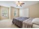 This bedroom features a ceiling fan, carpet, and a large window at 10906 Keys Gate Dr, Riverview, FL 33579