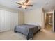 This bedroom features a ceiling fan, carpet, and a large closet at 10906 Keys Gate Dr, Riverview, FL 33579