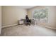 This bedroom features a large window, carpet, and is staged as an office at 10906 Keys Gate Dr, Riverview, FL 33579
