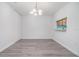 Minimalist dining area featuring wood floors, a chandelier, and access to the kitchen at 10906 Keys Gate Dr, Riverview, FL 33579