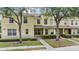 Inviting two-story townhome featuring a well-kept lawn and mature trees at 10906 Keys Gate Dr, Riverview, FL 33579