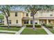 Charming townhome with a well-maintained lawn and lush shrubbery in a tranquil neighborhood at 10906 Keys Gate Dr, Riverview, FL 33579