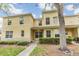Attractive two-story townhome showcasing a well-kept lawn and neat landscaping at 10906 Keys Gate Dr, Riverview, FL 33579