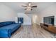 Open-concept living room with wood floors, stairway, and a comfortable blue couch at 10906 Keys Gate Dr, Riverview, FL 33579