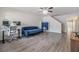 Comfortable living room showcasing wood floors, a couch, and a dedicated workspace at 10906 Keys Gate Dr, Riverview, FL 33579