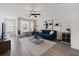 Bright living room featuring a blue sofa, modern decor, and a dedicated workspace by the window at 10906 Keys Gate Dr, Riverview, FL 33579