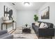 Cozy living room decorated with modern art, a comfortable gray sofa, and ample natural light at 10906 Keys Gate Dr, Riverview, FL 33579