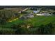 Stunning aerial view of sprawling estate with lush green pastures and well-lit grounds at 11602 Innfields Dr, Odessa, FL 33556