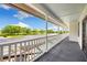 Outdoor balcony with fencing offers panoramic views of the pool, yard, and surrounding greenery at 11602 Innfields Dr, Odessa, FL 33556