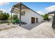 Durable barn with an attached shelter, featuring a concrete drive and ample space for vehicles at 11602 Innfields Dr, Odessa, FL 33556