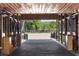 View of a barn interior with brick flooring and a view of the pasture at 11602 Innfields Dr, Odessa, FL 33556