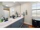 Bright bathroom boasts double sinks, a large mirror, and modern fixtures, creating a functional space at 11602 Innfields Dr, Odessa, FL 33556