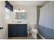 Bathroom with vanity, updated lighting, and shower with curtain at 11602 Innfields Dr, Odessa, FL 33556